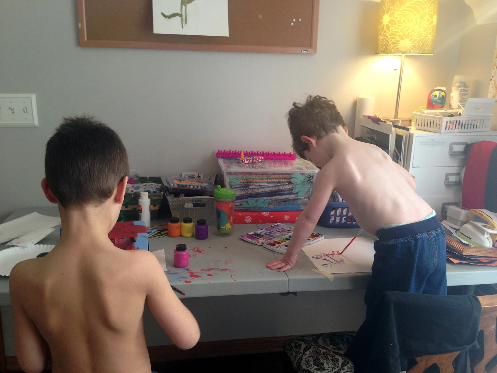 The brother's painting. Of course, little brother had to take his shirt off like big brother.