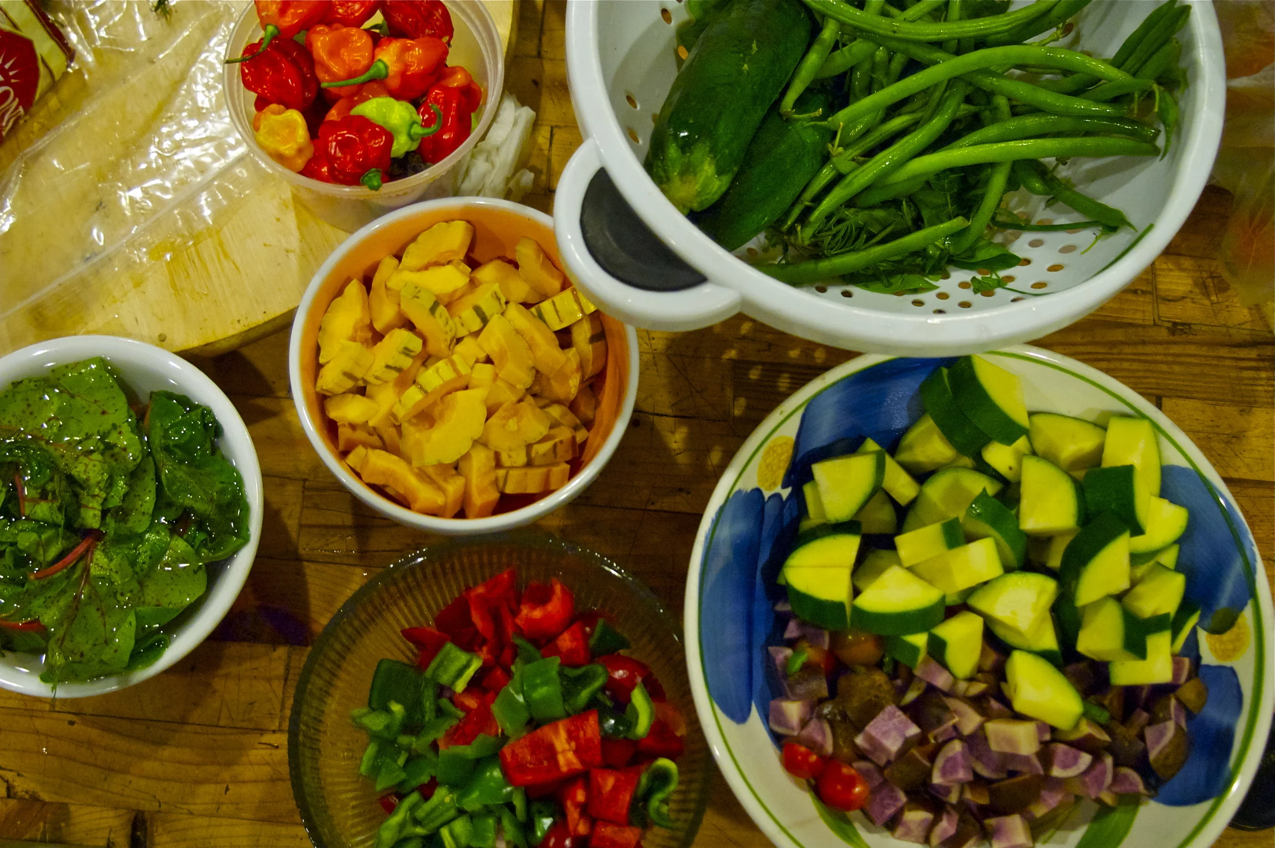 summer's abundance: mise en place of delicata squash, chard, green beans, zucchini's, habanero peppers, purple potato + bell peppers