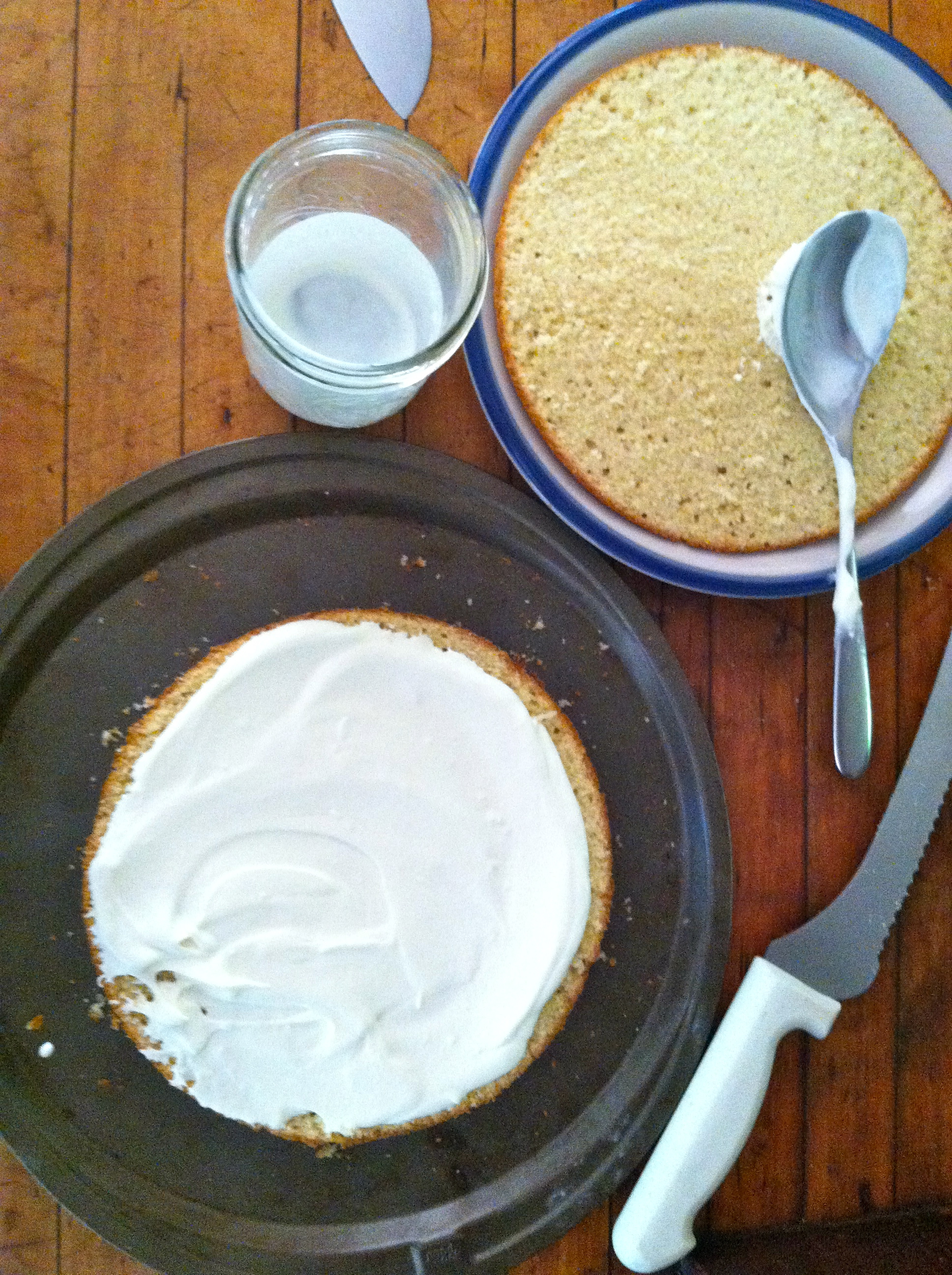 Assembling the cake with layers of whipped cream 