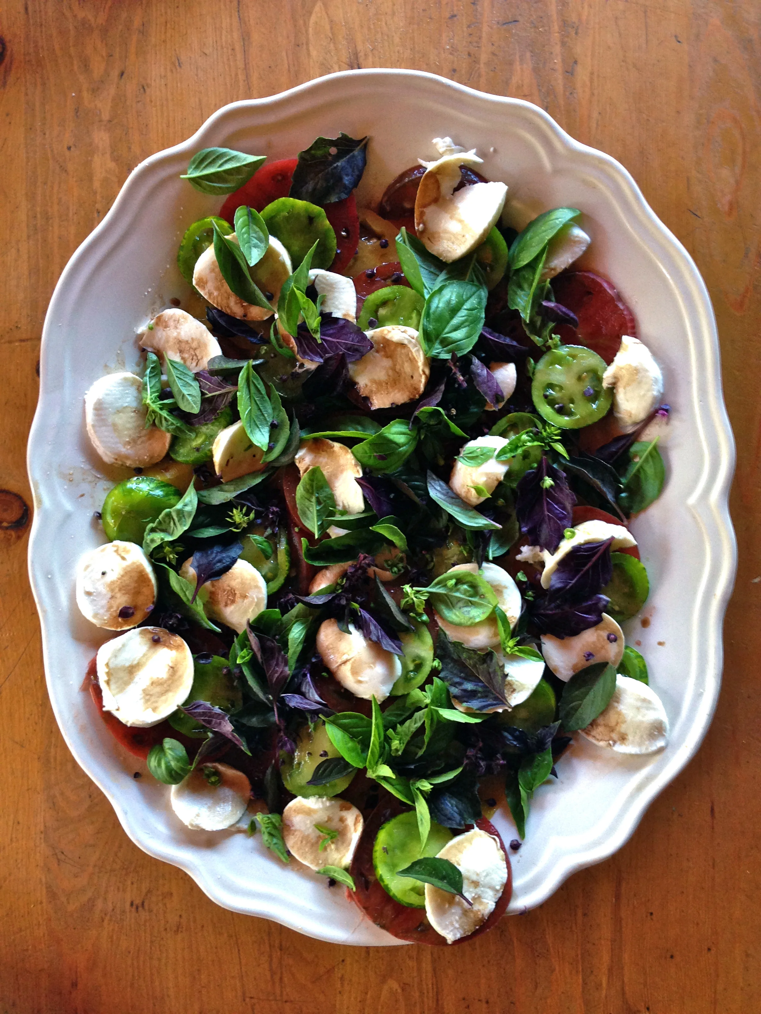 Dea's Insalata Caprese with zebra green+ purple cherokee tomatoes with bocconcini mozzarella, licorice basil, balsamic + olive oil 