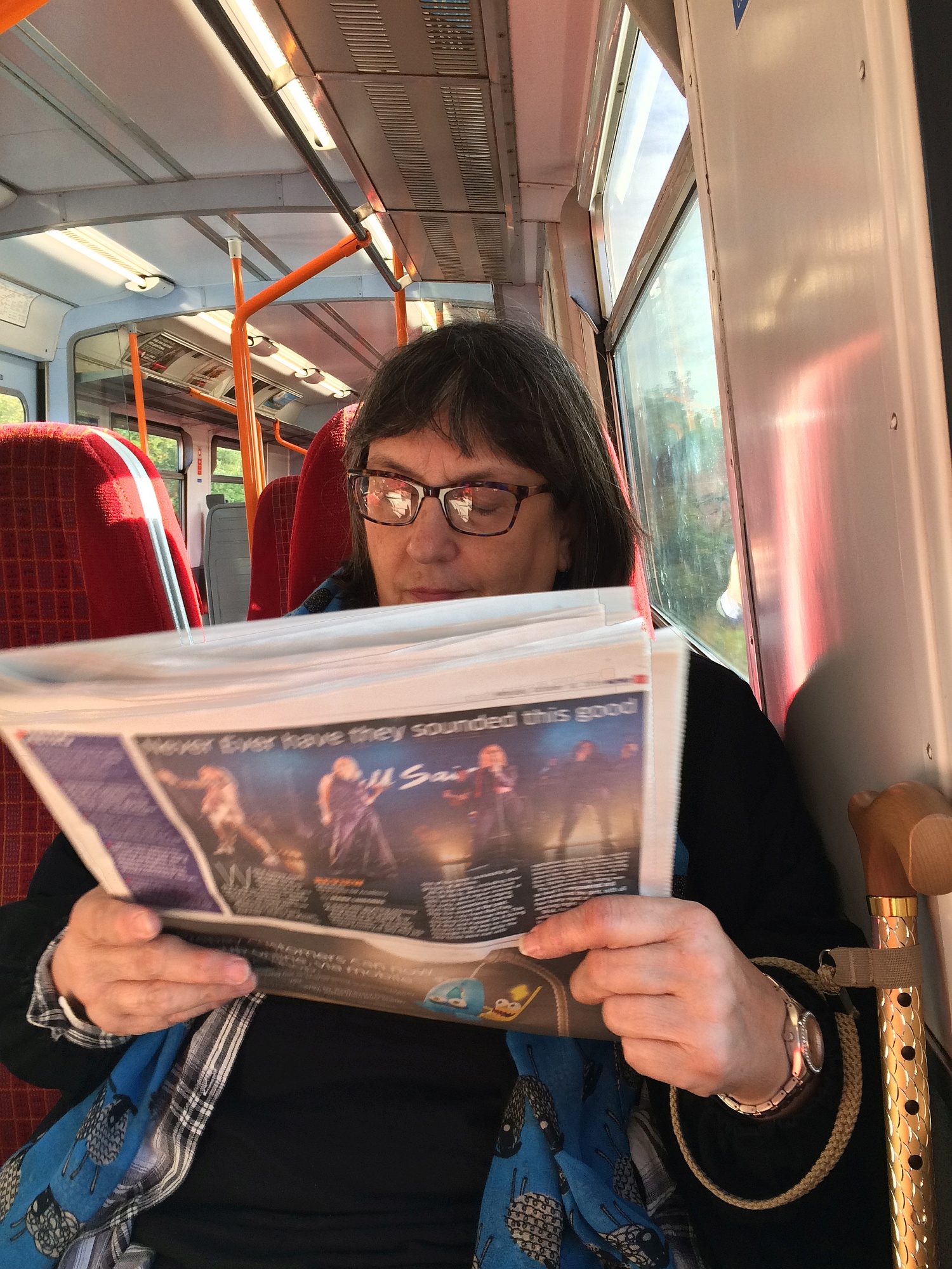 Norah enjoying the free newspaper they give our morning and evening at all transport stops. A different paper each morning and evening. Print media still has lots of legs in the UK.