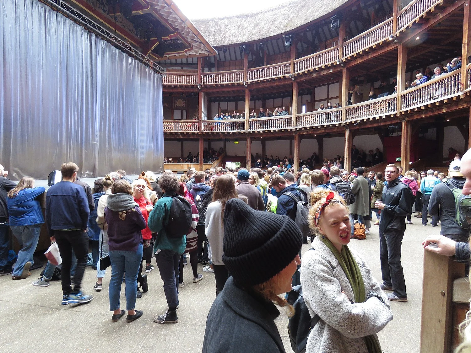 Our view, sitting just behind the groundlings, who stand. The "shower curtains" surrounding the stage were used to good effect, giving an industrial feel to the production.