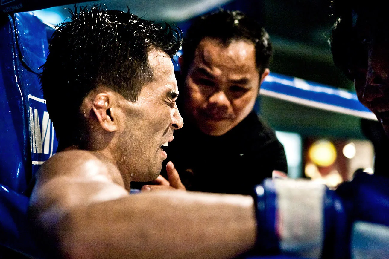 A Muay Thai fighter resting between rounds - Bangkok, Thailand