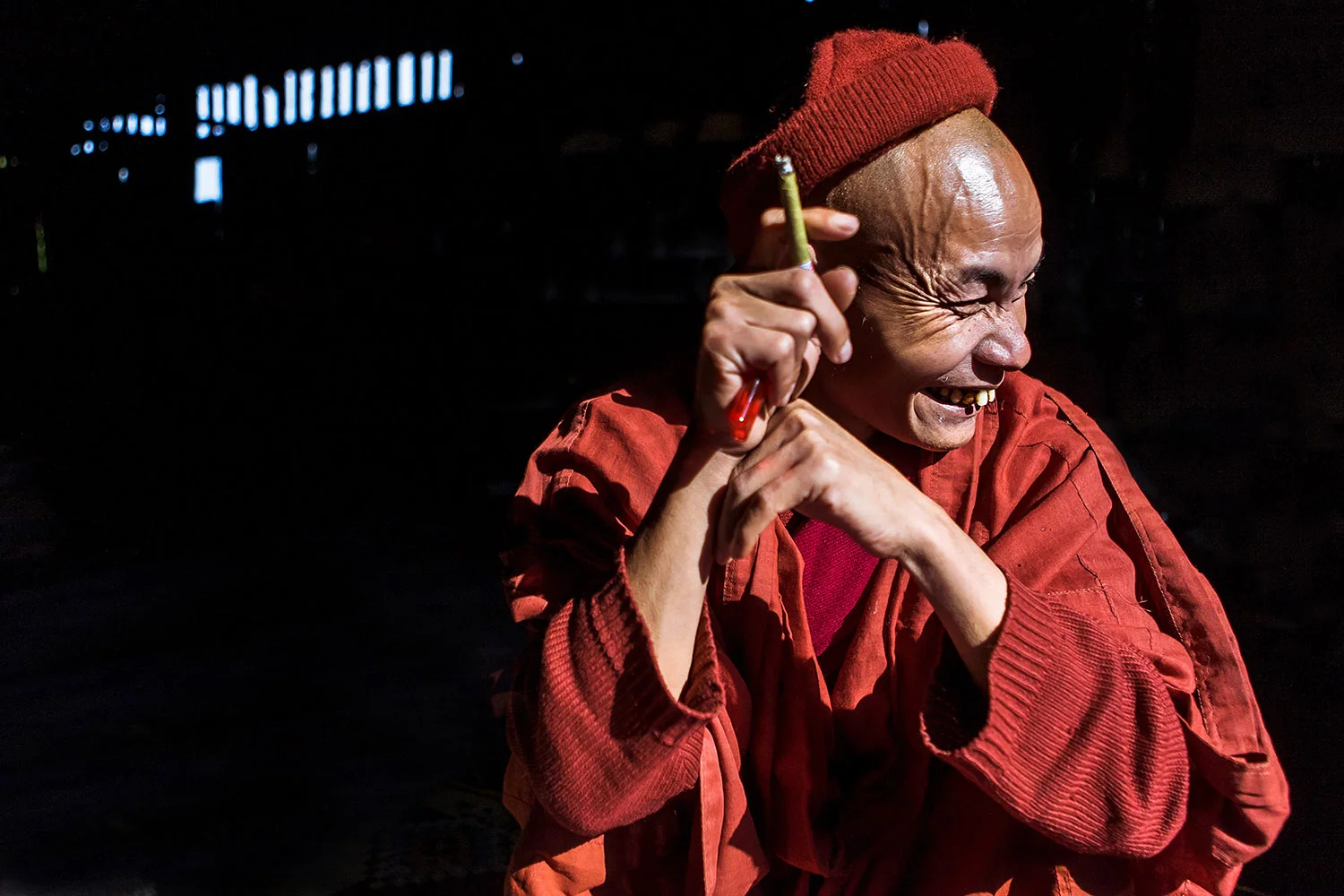 A chief monk smoking a morning cigar at the monastery's dining room - mountains around Kalaw, Burma (Myanmar)