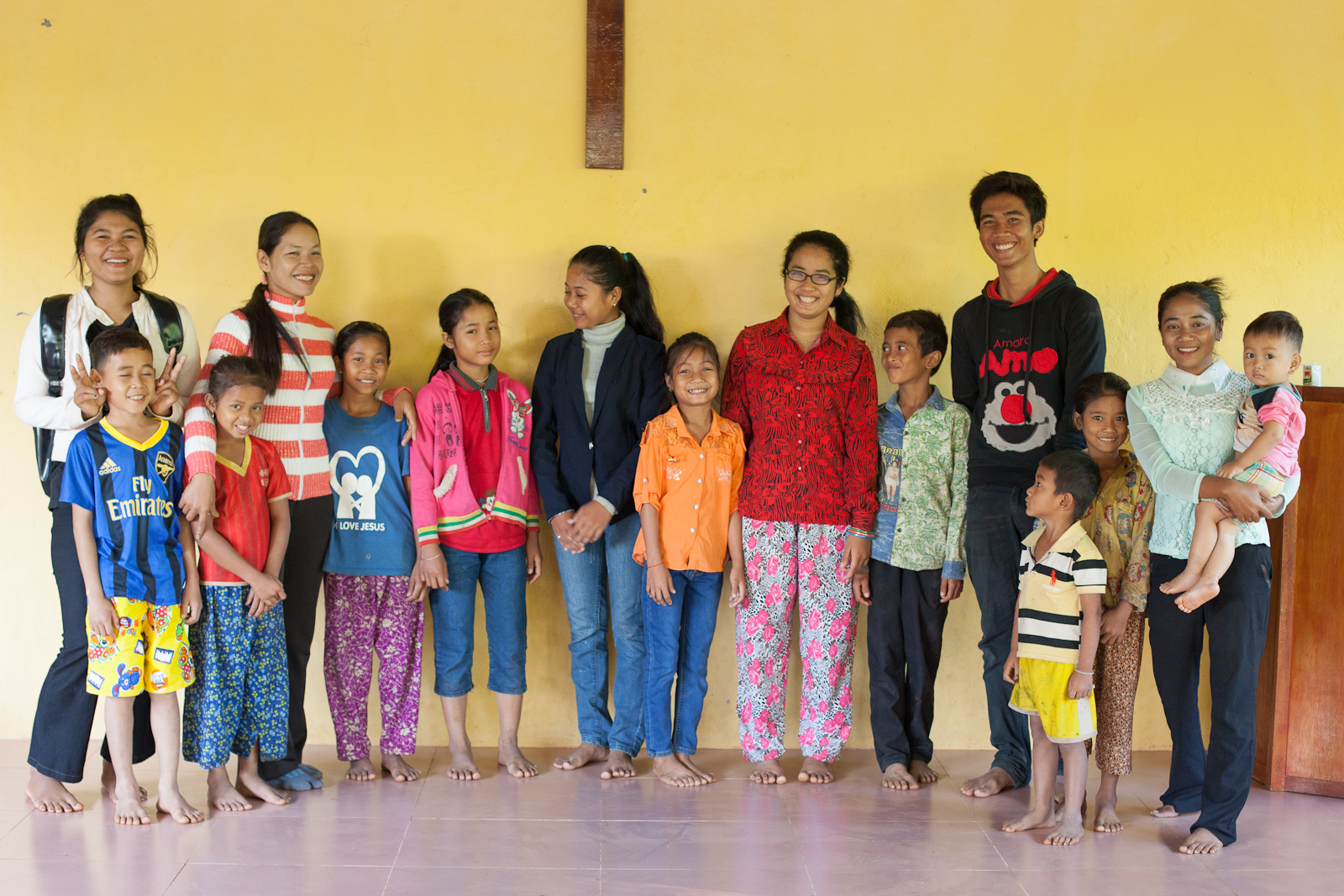 Alongsiders with their little brothers and sisters and a few extras. Chanthy is wearing orange and white stripes. Piya and her little brother are on the right in yellow.