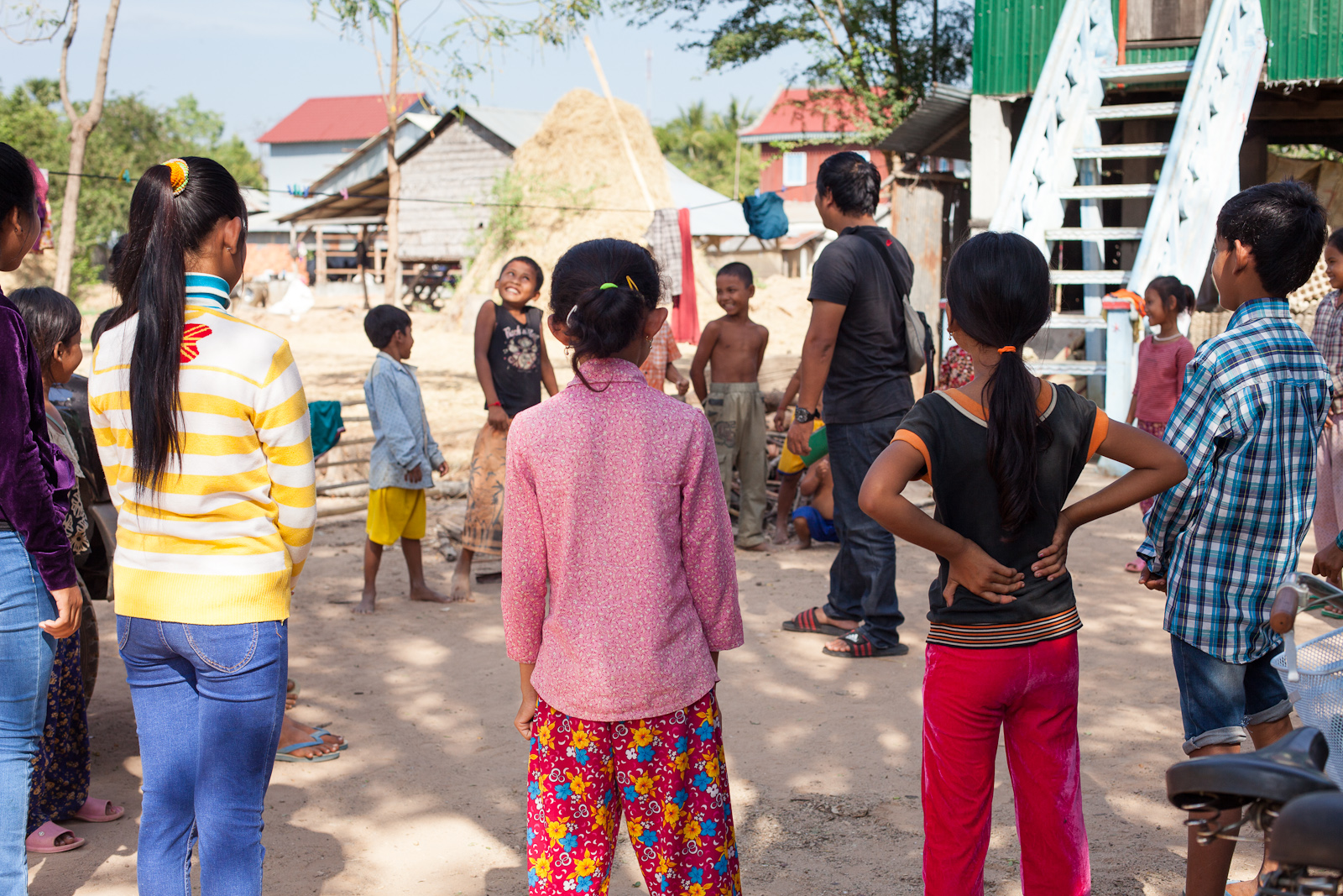Phearom leads a group of little brothers/sisters in a warm up game
