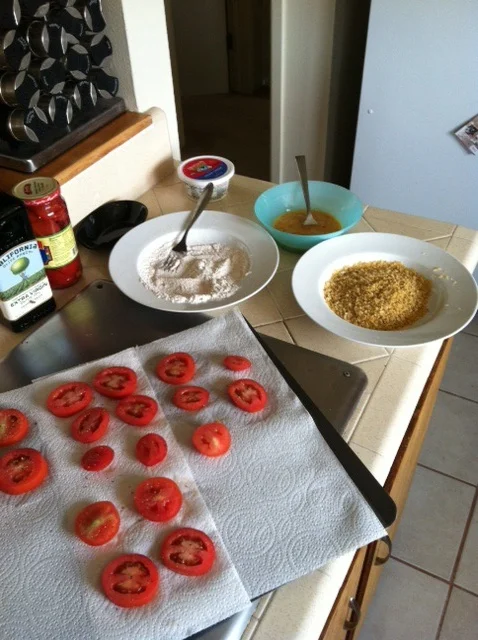 Slice tomatoes and put flour and bread crumb mixtures in bowls near stove top.