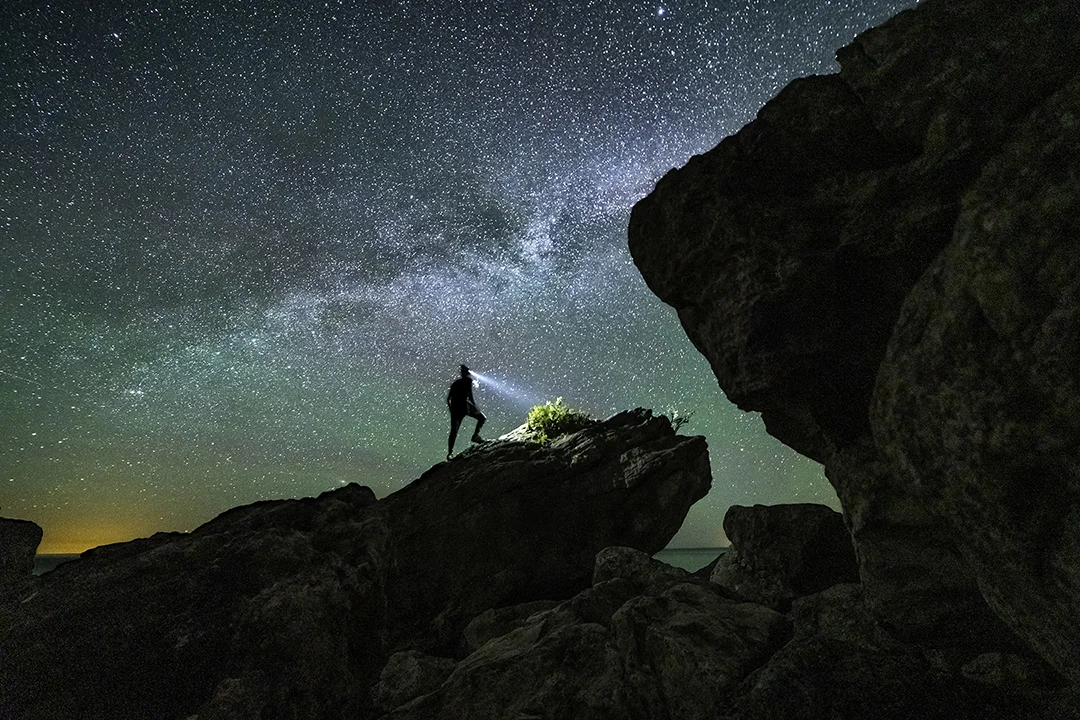 Taking in the starry views from atop a rock