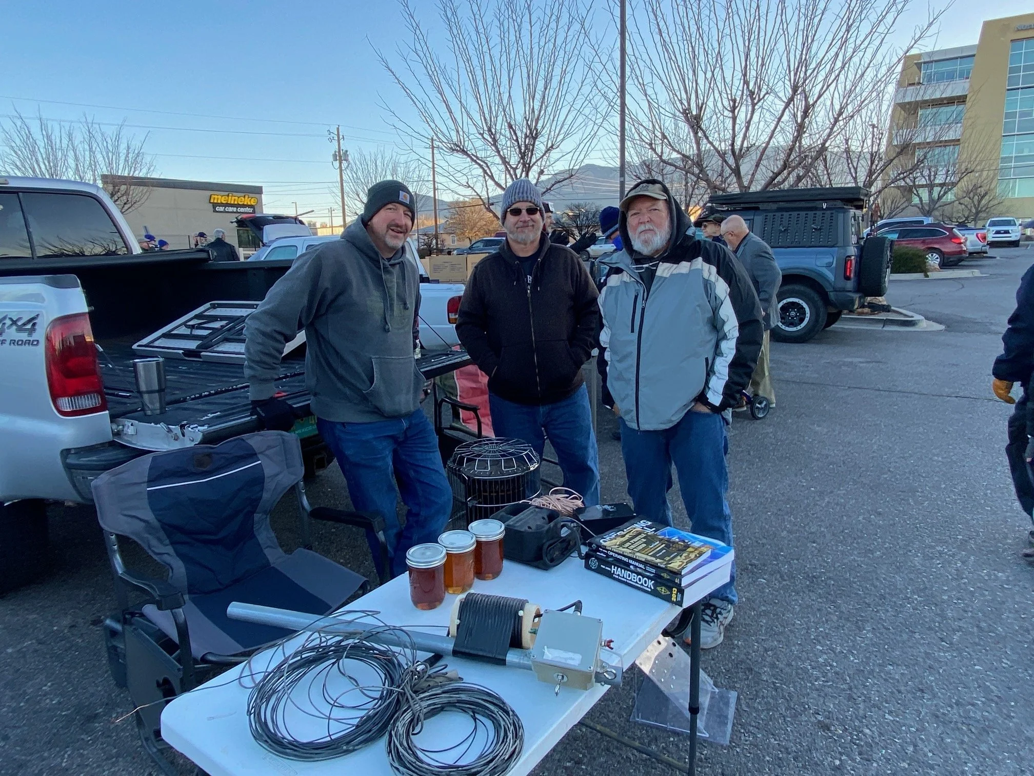 Greg W5ER (left) with his home-grown honey for sale.