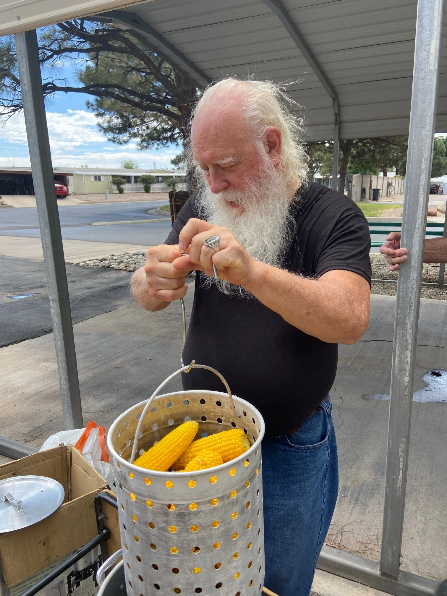 Chef Dave KI5MYX pulling corn out of cooker.