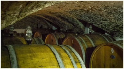 Volpaia - barrel storage in cellar under the village church - note the use of the barrel seal mechanism as designed by Da Vinci