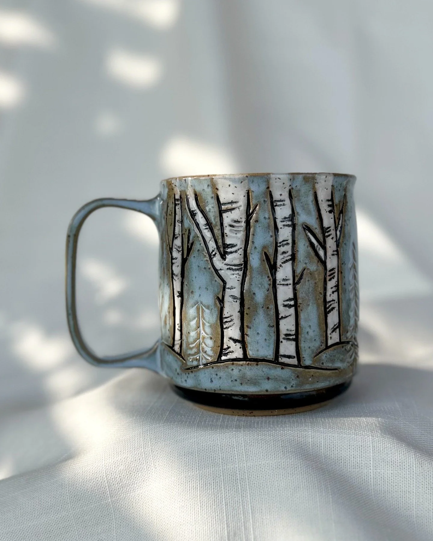 Coffee tastes better in the woods 🌲☕

Hand-carved birch trees on a soft blue #spectrumglaze for a peaceful morning. 

#wheelthrown #handmadewithlove❤️ #ceramicstudio #ceramicartist #potterystudio #potterywheel #mugsofinstagram #spectrumglazes #funct