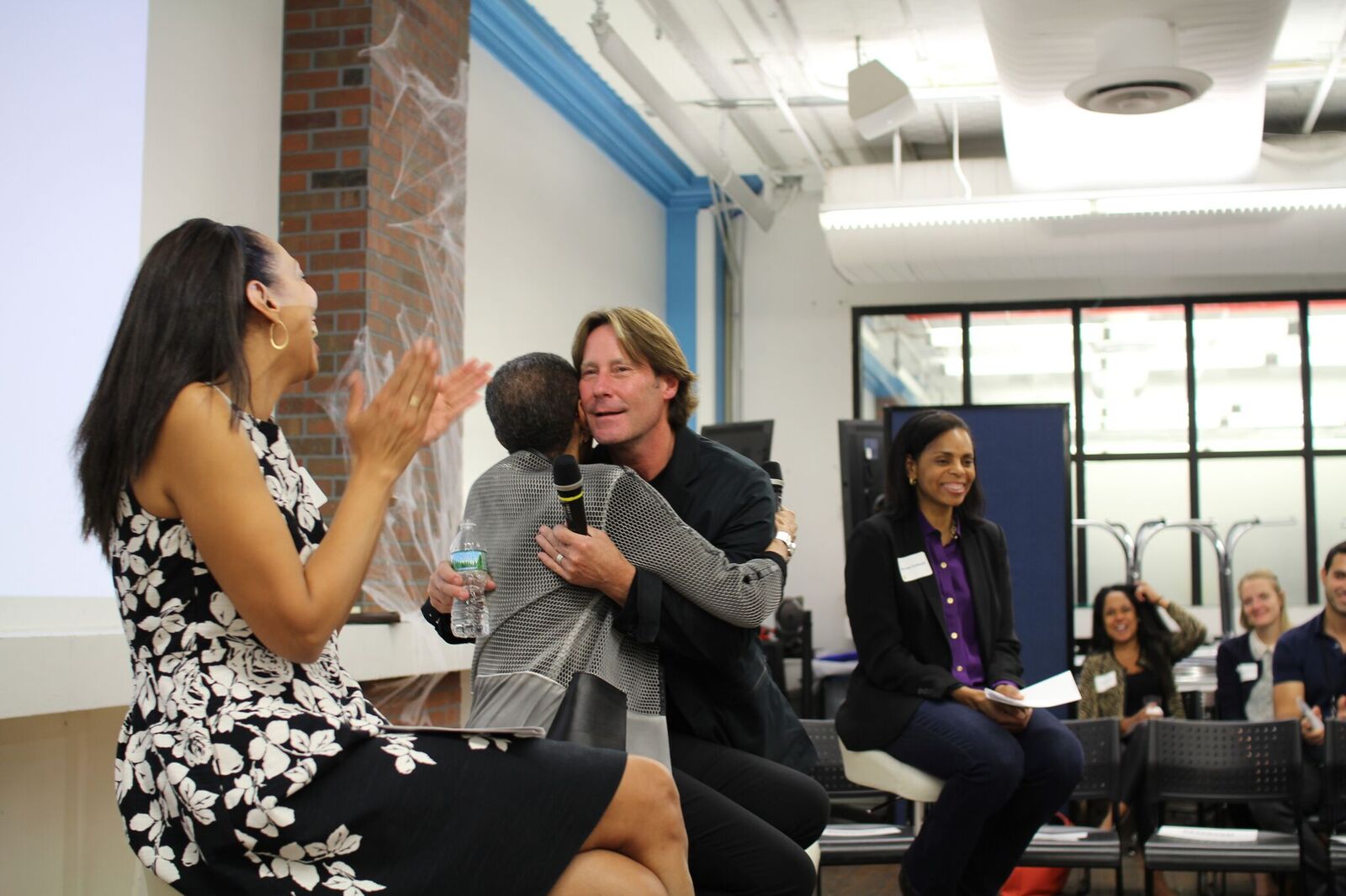 Panelists hug.jpeg