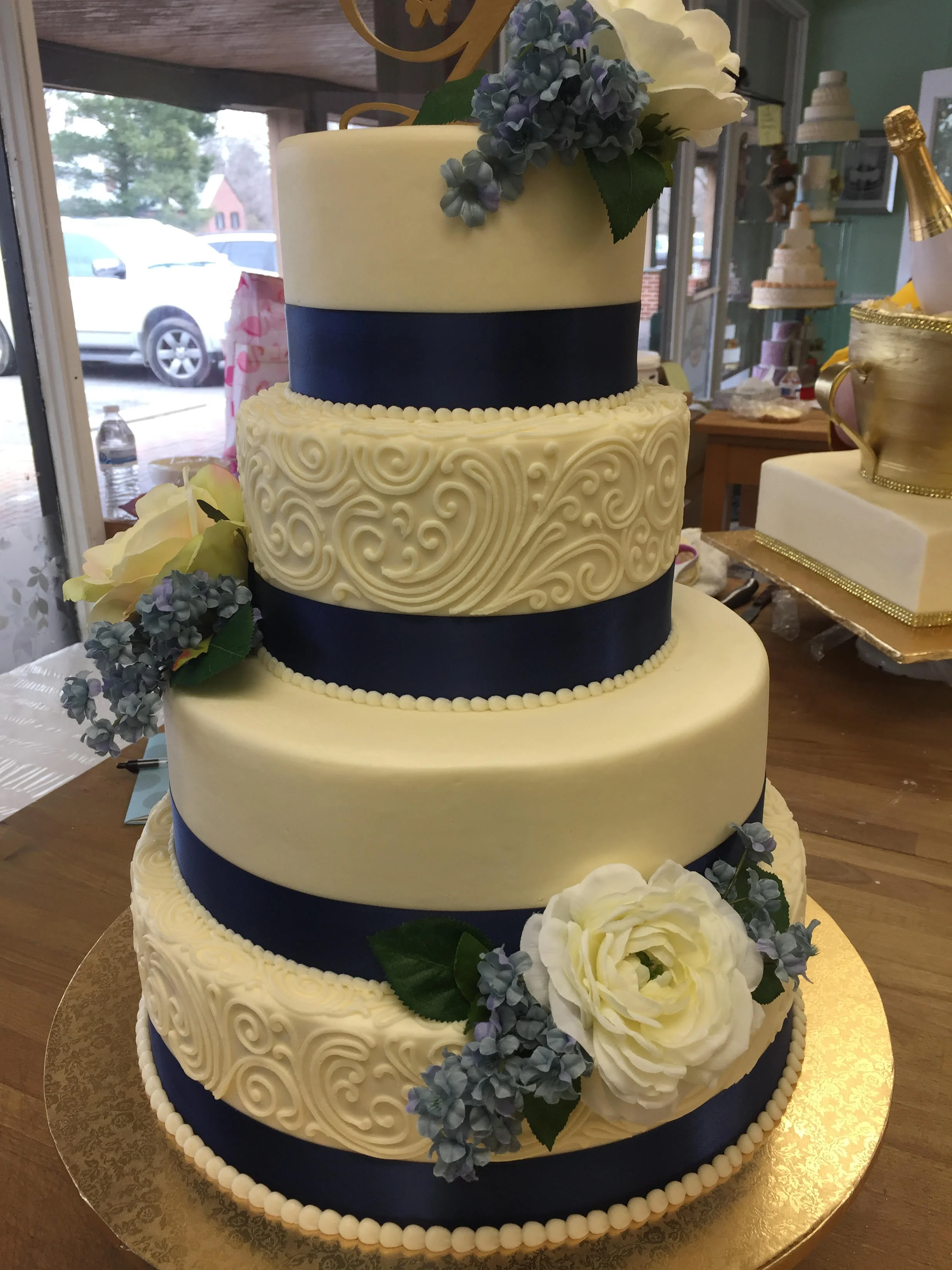 Four Tier Blue Ribbon and Flowers Wedding Cake