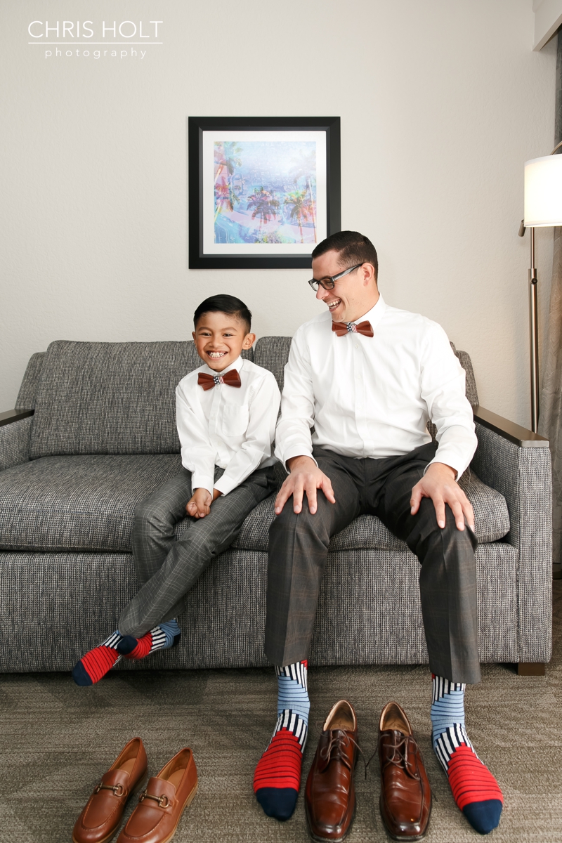 groom and son putting their shoes on