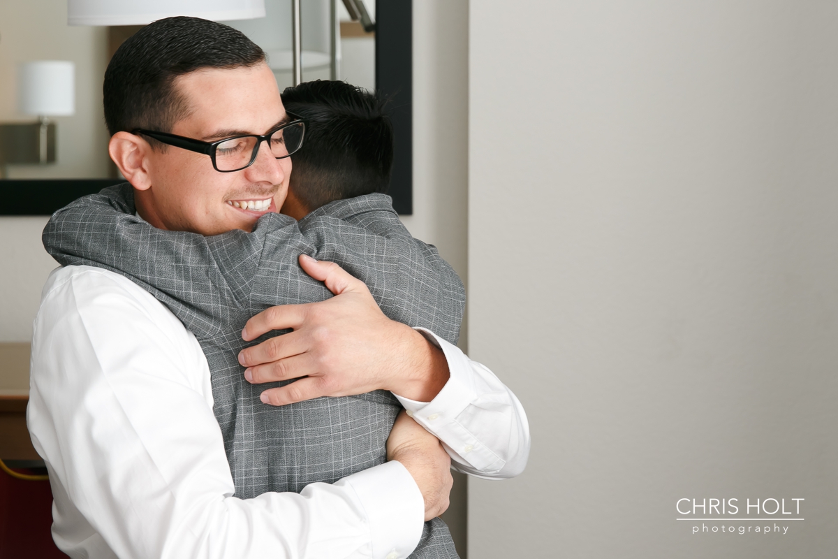 son hugging his dad the groom