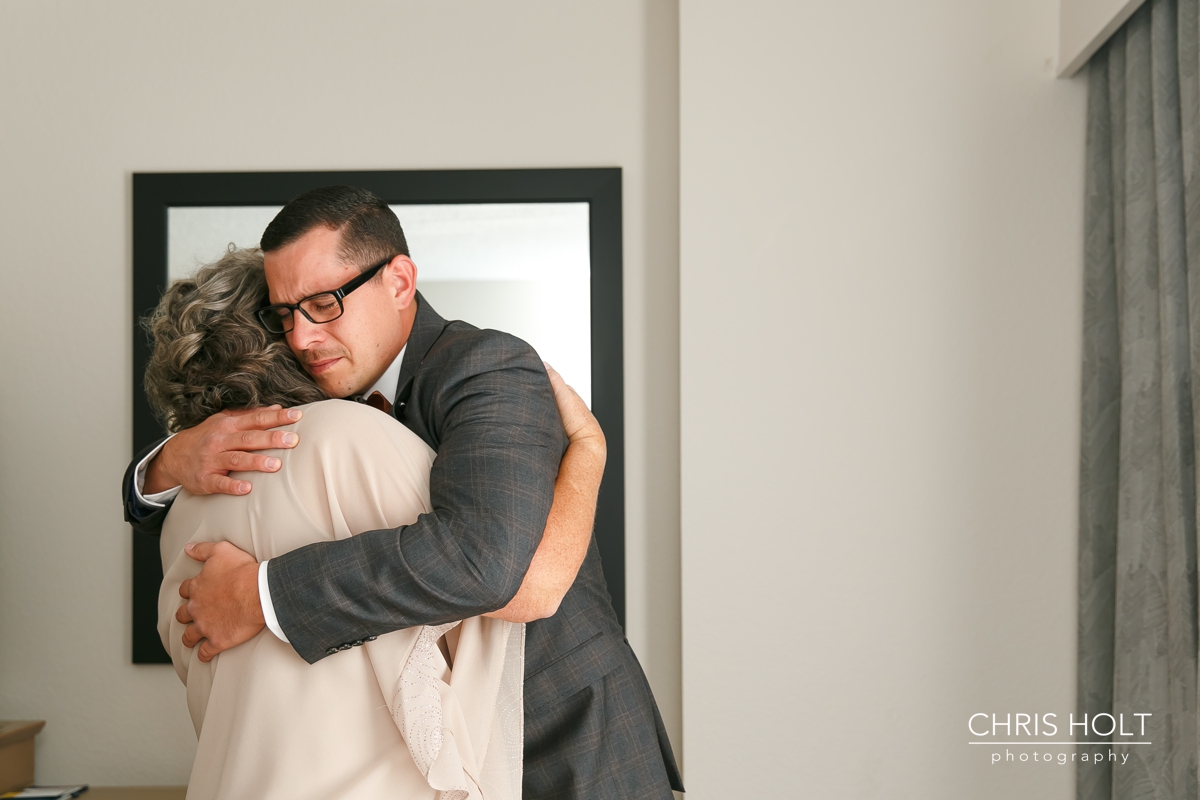 mother and groom hugging before the ceremony