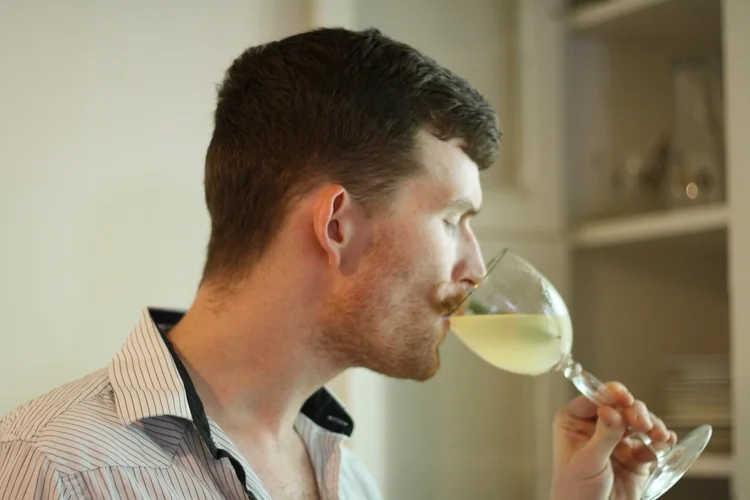 Bartender and mustache-haver Thomas Paessler enjoying a "pink pearl." 