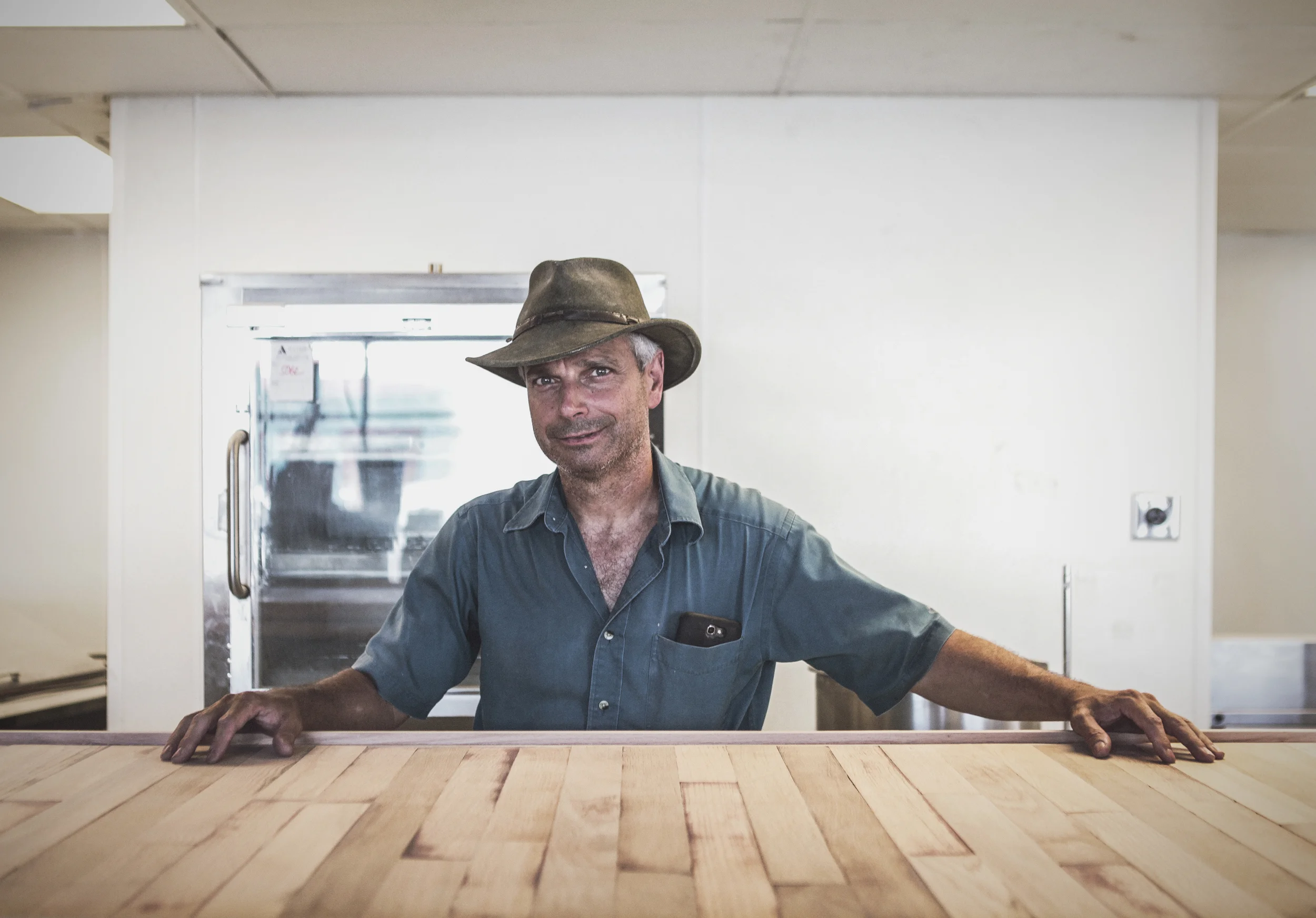 Erik Stensen at the helm of the bar at the new Hoochie's location at Industrial and Hickory. 