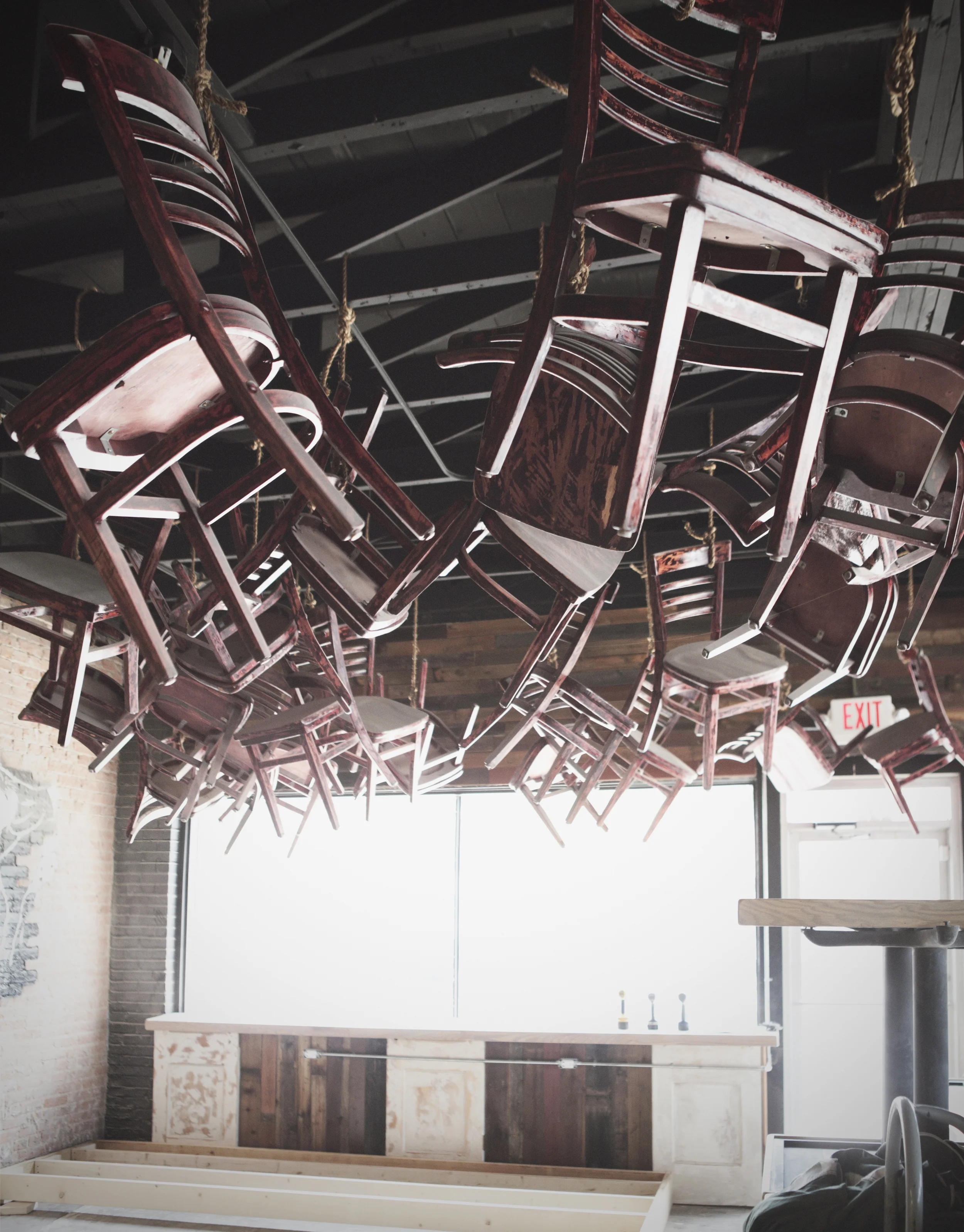 Chairs from Burguesa are strung up on the ceiling. 