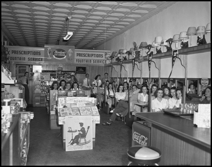 1942 Photograph of customers at the Hamilton Drug Store in Denton, with a display of Mother's Day cards sitting in the center of the room. Photo from TexasHistory.unt.edu. 