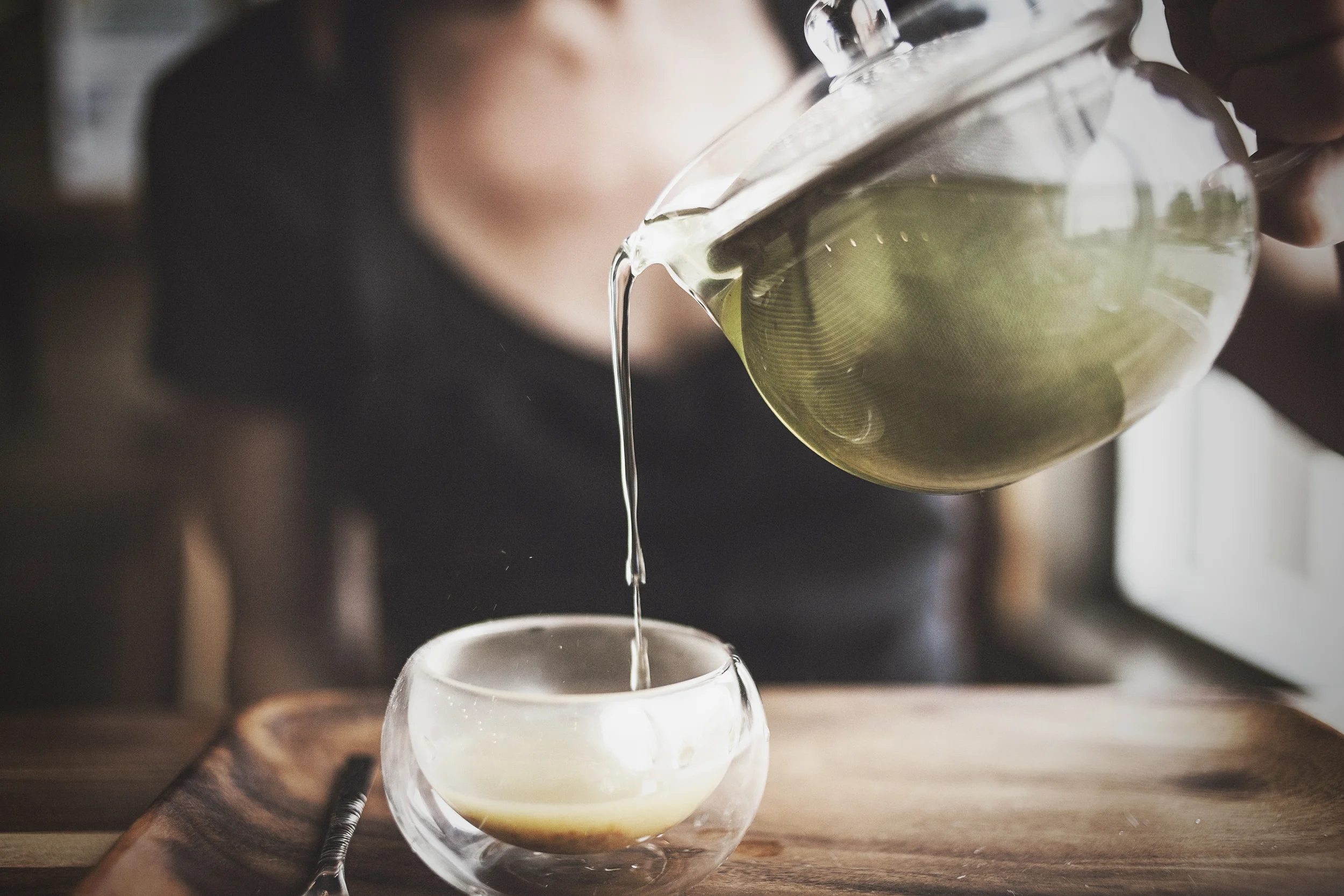 Andie Sterling pouring hot green tea over some bee pollen, as one does. Photo by Will Milne.