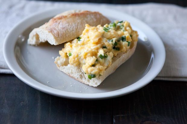 baguette with chevre scrambled eggs. this is the PERFECT "friends over for brunch" dish. with entertaining, i say keep it simple! toast a baguette, scramble the eggs, toss them in, serve with fruit salad and mimosas. i didn't divide the bread - i brought the whole baquette out to the table and sliced at the table. much more communal that way! 