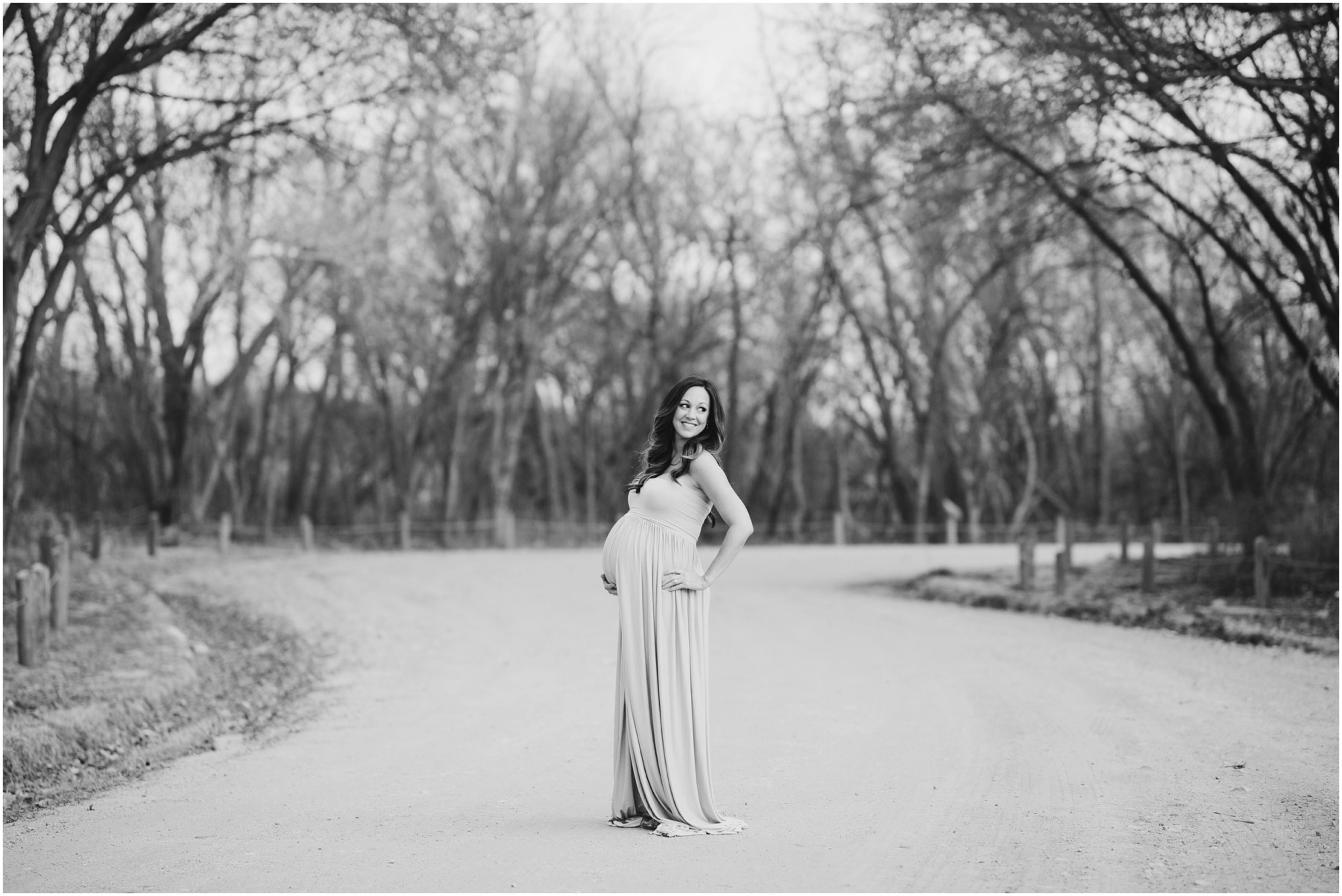 black and white posed maternity photo outside trees