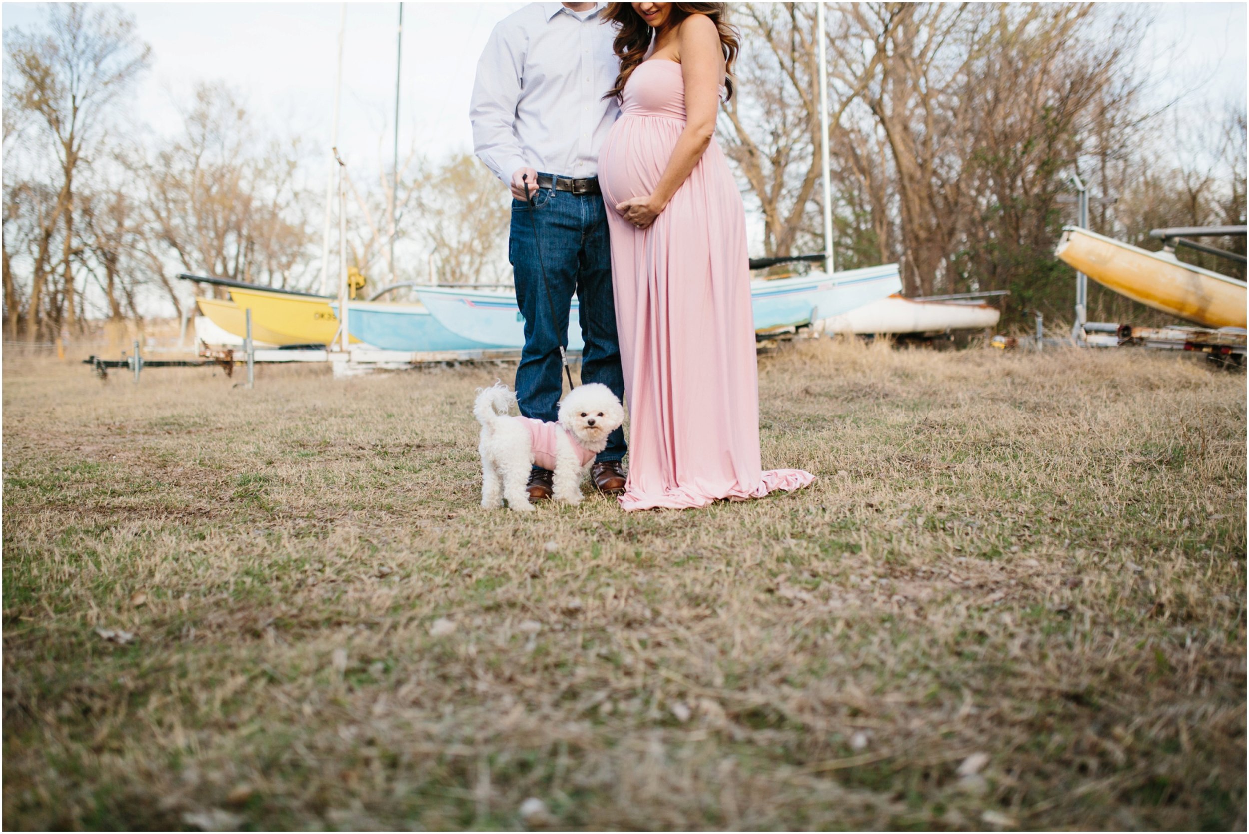 couples pregnancy photos with dog by blue and yellow sailboats in okc