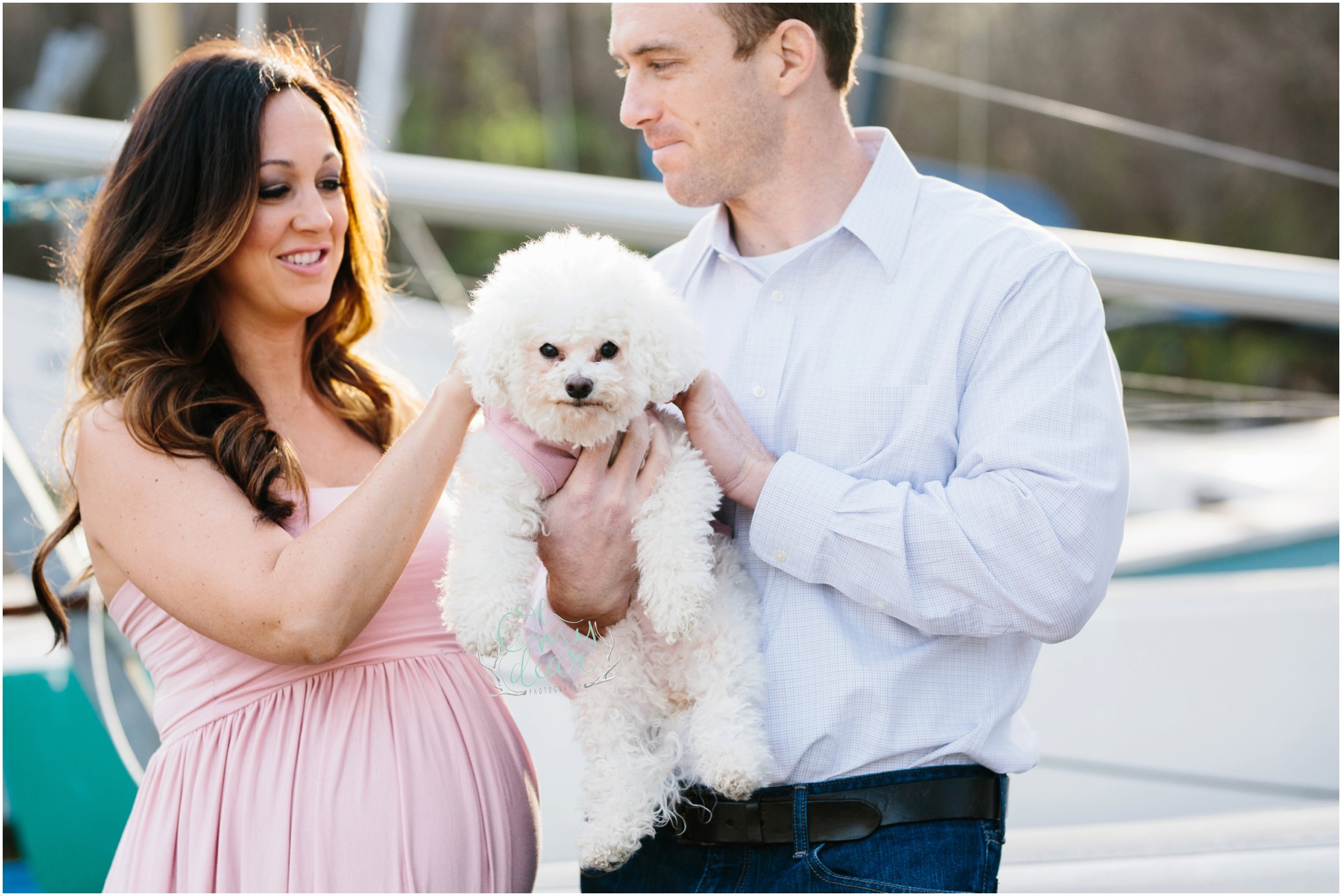 family photo with small dog by sailboats in oklahoma city at lake hefner