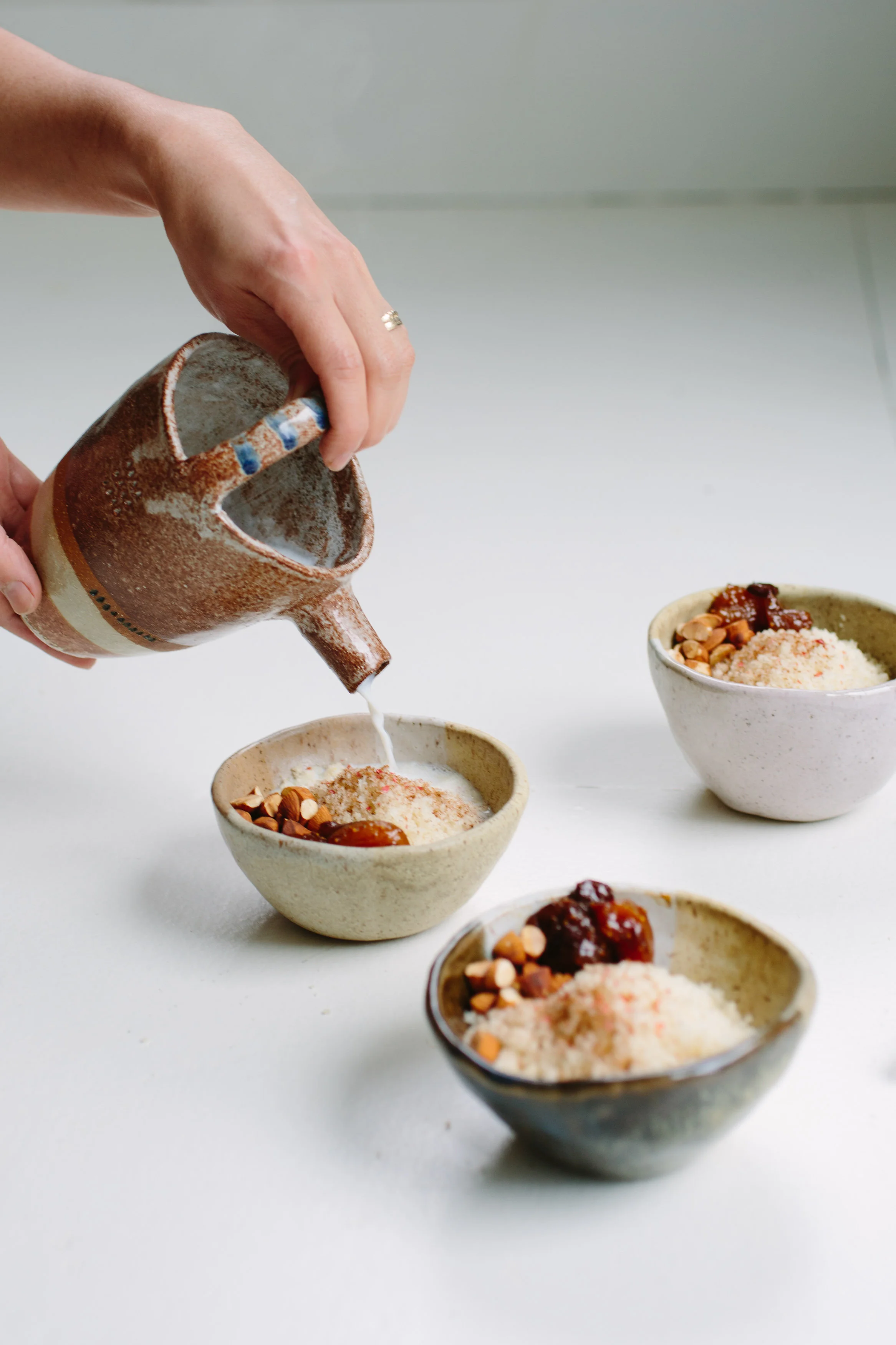 Couscous No. 1 Jajo served as a sweet morning dish with dried fruit preserve, roasted almonds, cinnamon and hot spices milk. Photography: Christine Han, Ceramics: Shino Takeda