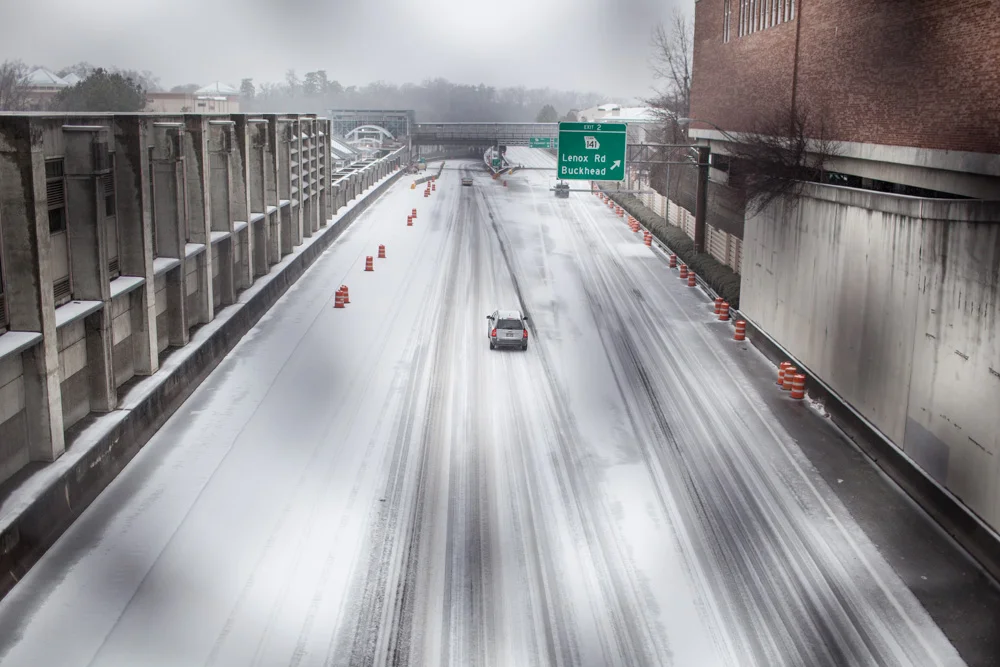 A car veers onto the on-ramp for GA-400, headed northbound.