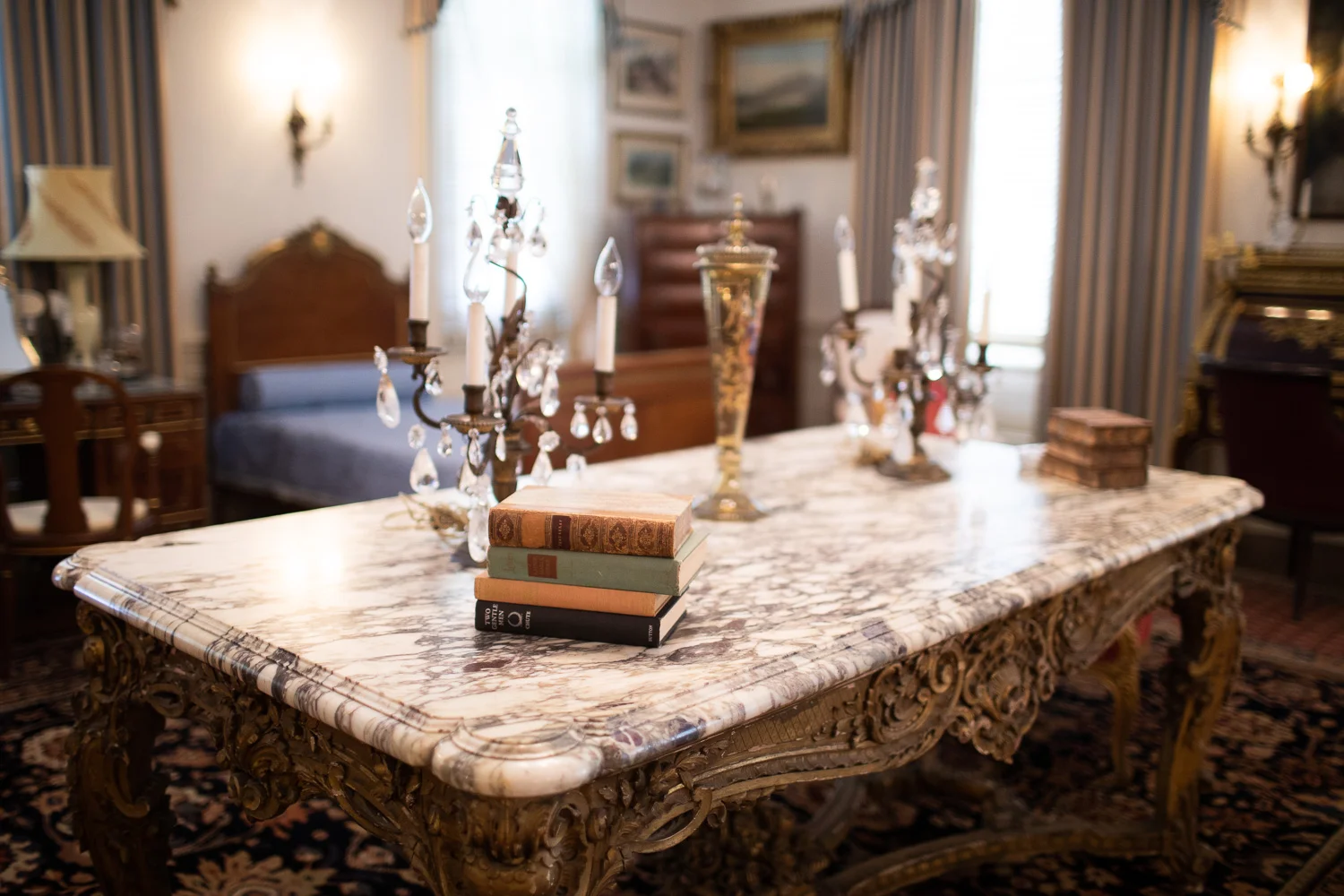 Books and candles on an elegant marble table.