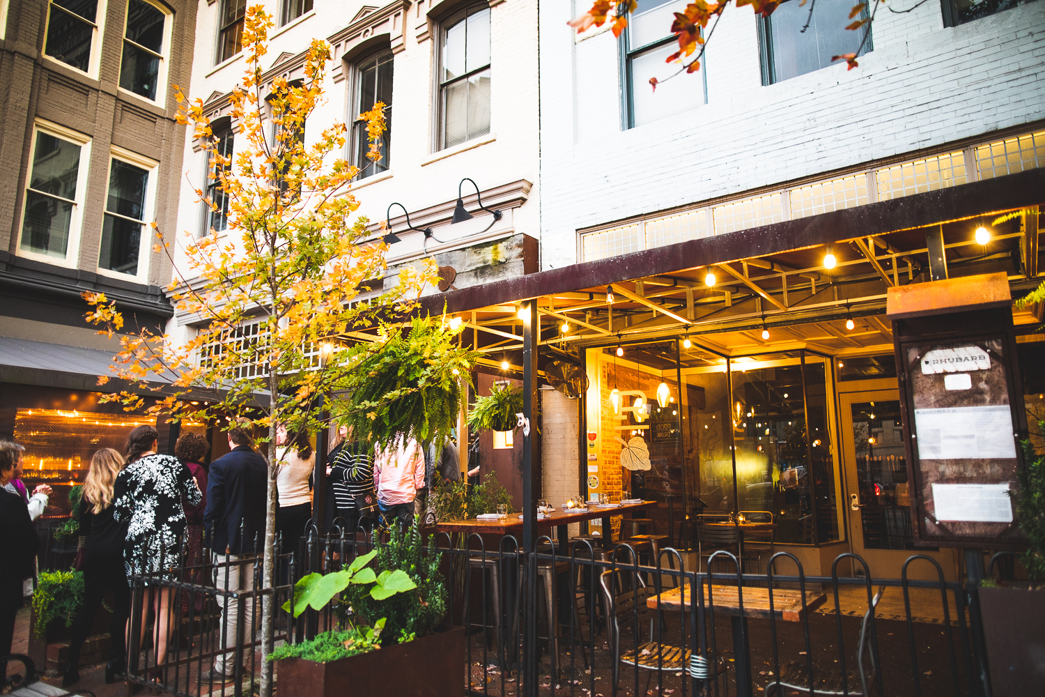 A long line of patrons waiting to get seated at Rhubarb for dinner.