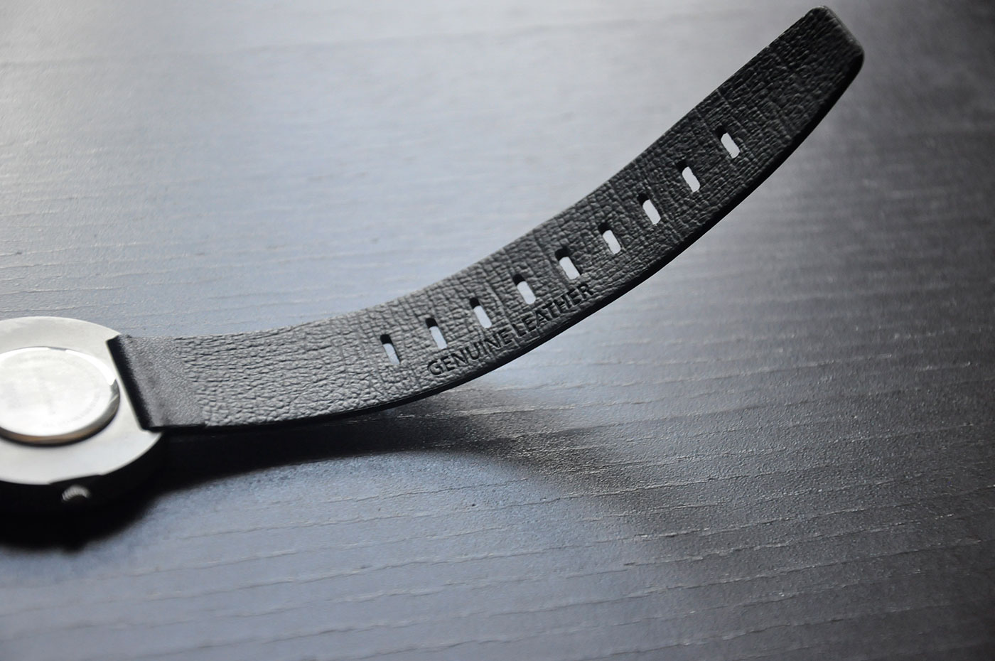 On the bottom strap, we see "Genuine Leather" text embossed. The placement is great. There are nine holes for size adjustment. They are rectangular in shape with rounded corners, which should prevent hole enlargement with use. 