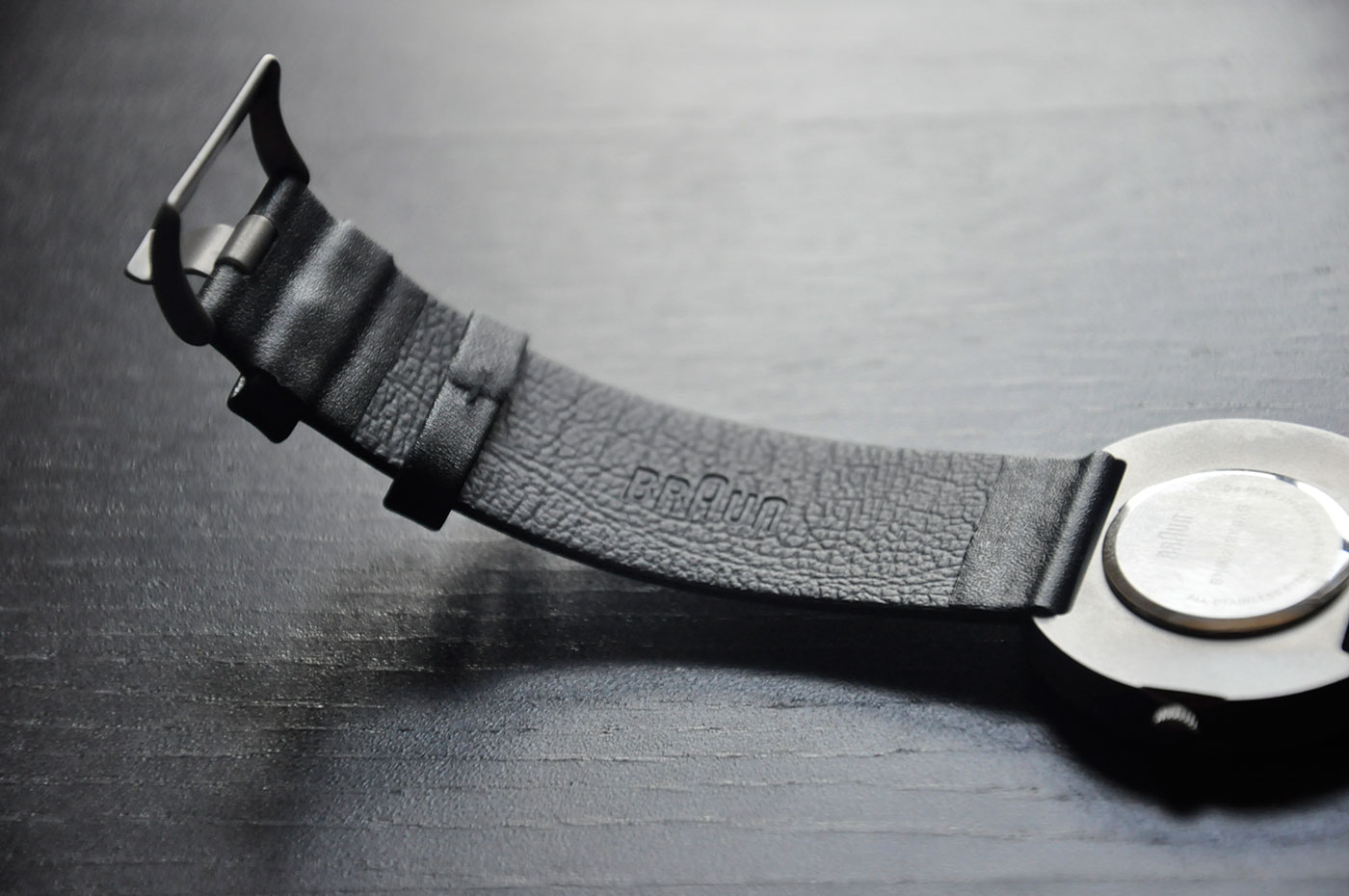 On the inside of the leather strap, the top strap has the Braun logo embossed. The strap loop leaves more to be desired. A single stitch holds it in place. 