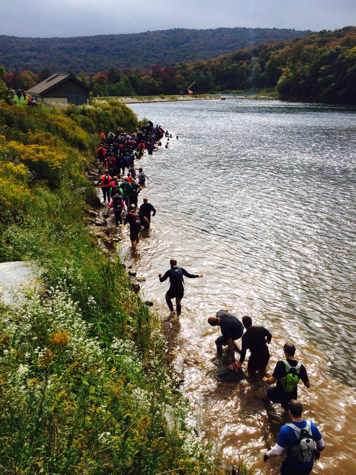Wading through the water immediately after doing our penalty burpees. Photo credit Obstacle Racing Media