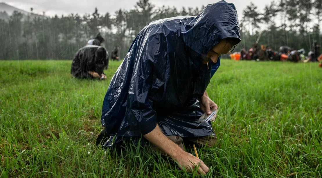 Planting seeds, feeling nice and warm under my rain jacket! Photo Credit: Amanda Suarez / M+F Magazine