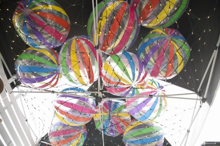  Above, 20 beach balls and pixie lights add fun and dimensions.&nbsp; 