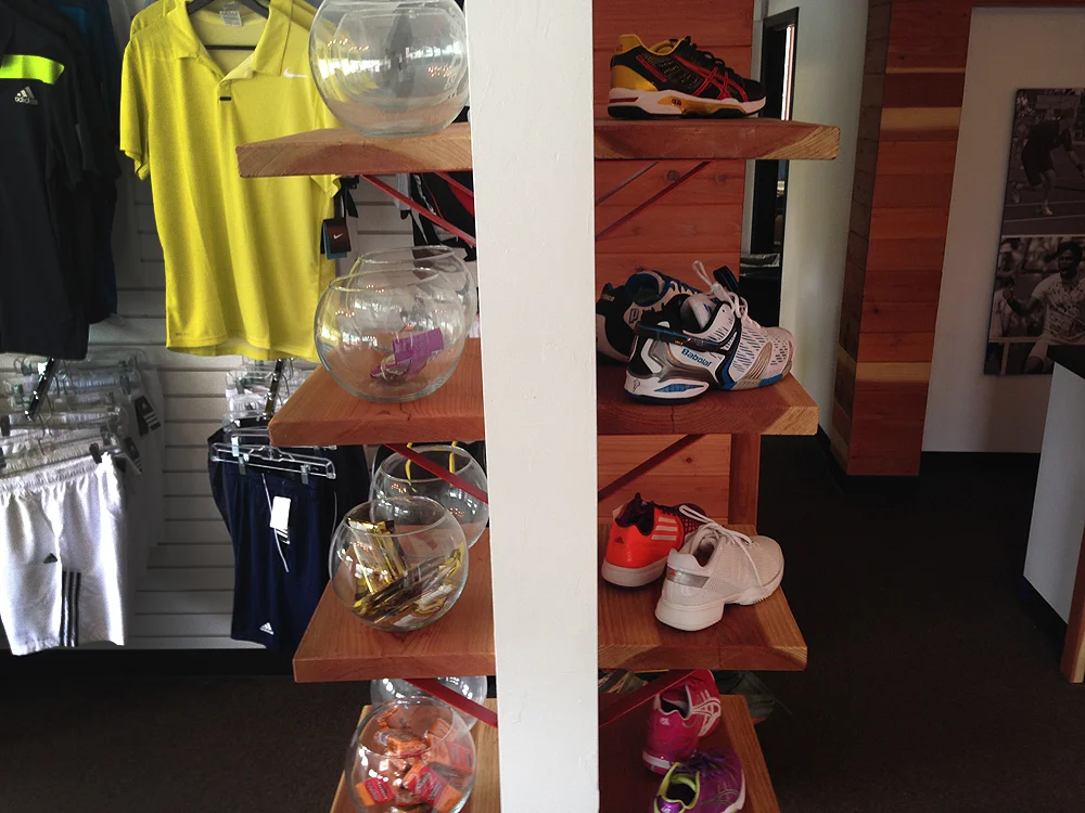 A support column, previously hidden, got high visibility custom shelving for snack jars and footwear, both high revenue drivers for the club. 