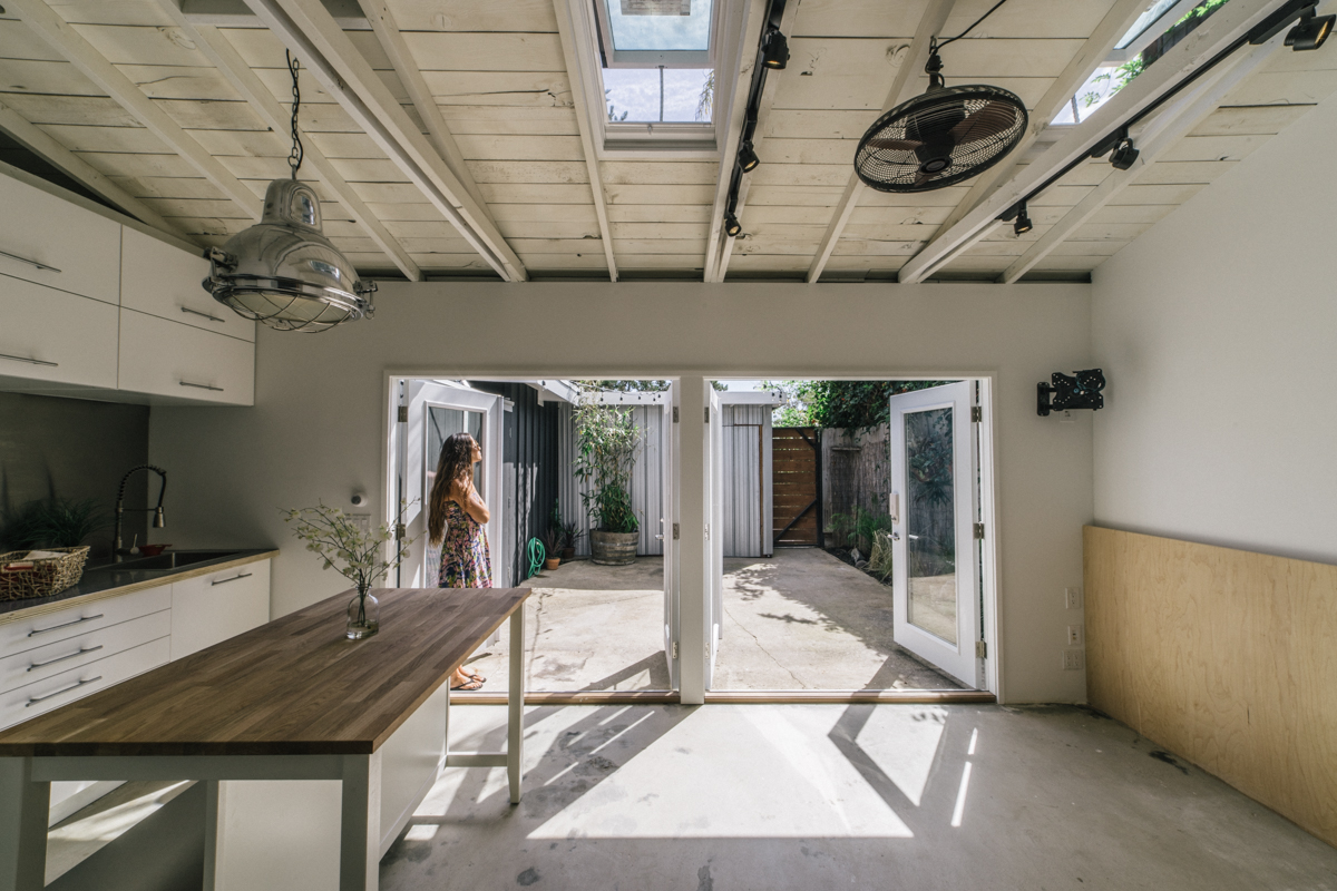 The living and kitchen space flows out to the courtyard thanks to 15' of french doors, making the space feel much larger. 