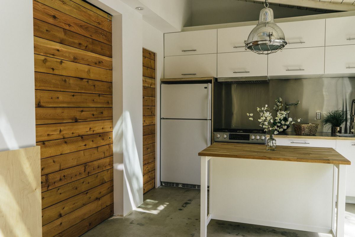 The doors to the bath and bedrooms were custom built out of cedar and sealed clear. The bedroom door is 5-feet wide and 8-feet hight, mounted with barn door hardware. When open, the space feels huge like a hotel suite. 