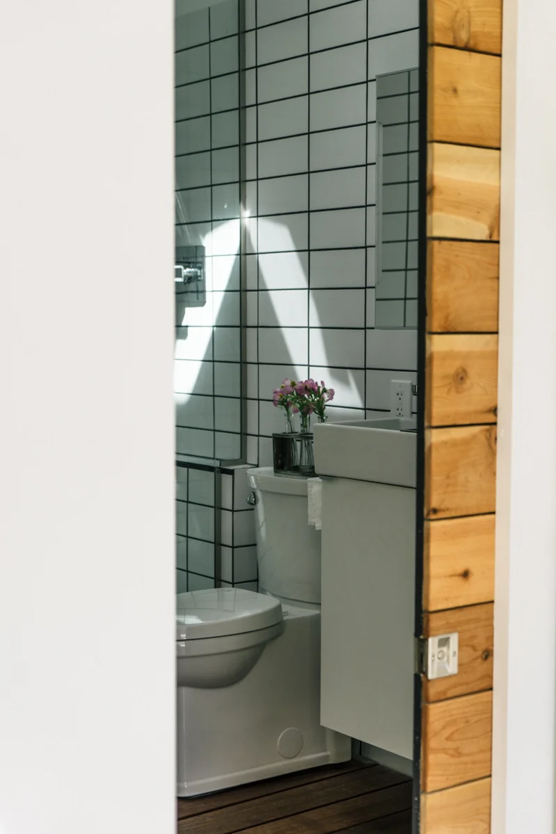 Pocket door to the bathroom to maximize every inch. 