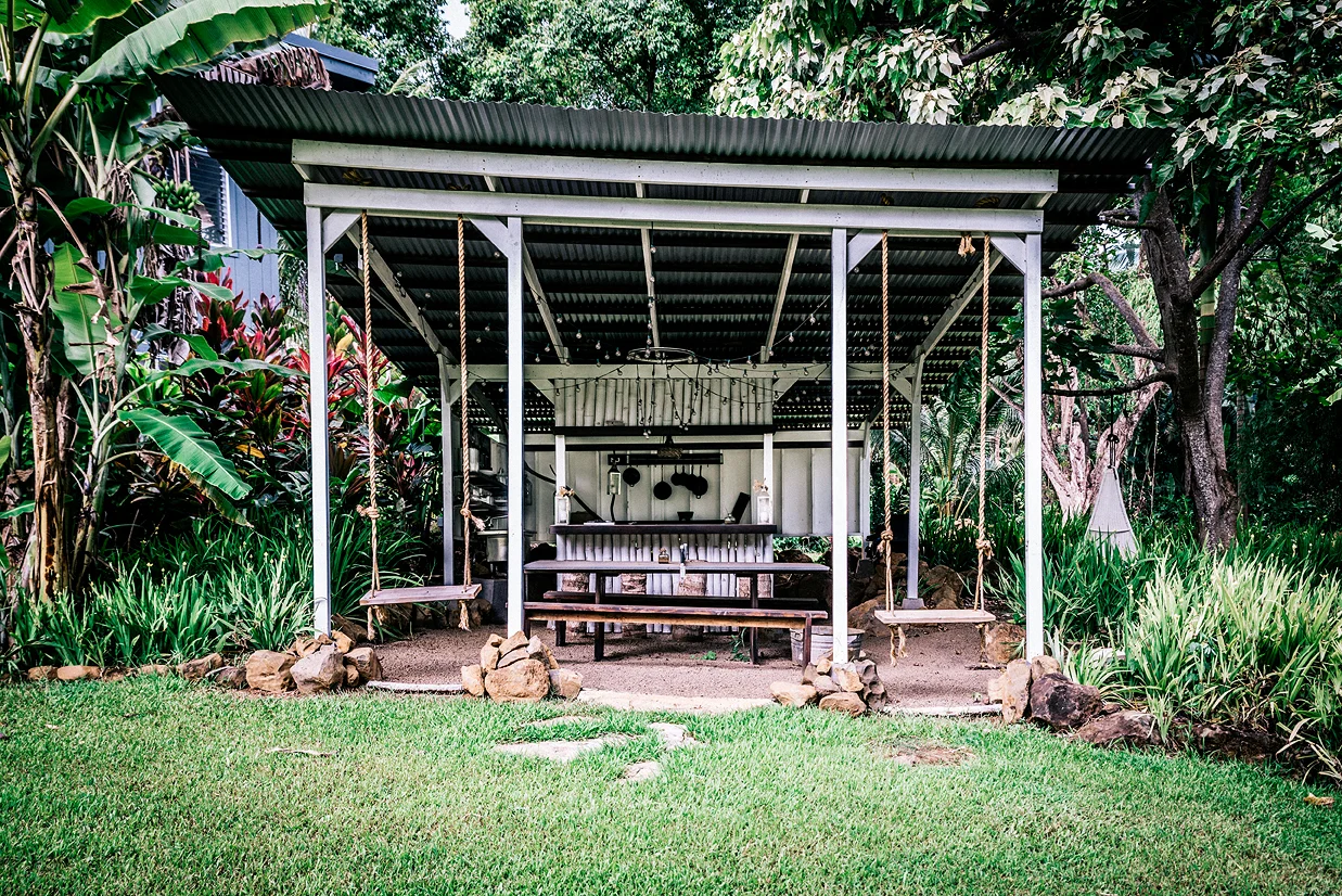 The outdoor bbq are and bar features swings at the entry. 
