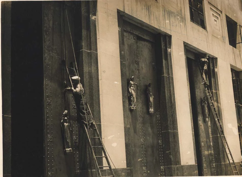 "Two workers installing the doors of the Davidson County Courthouse"