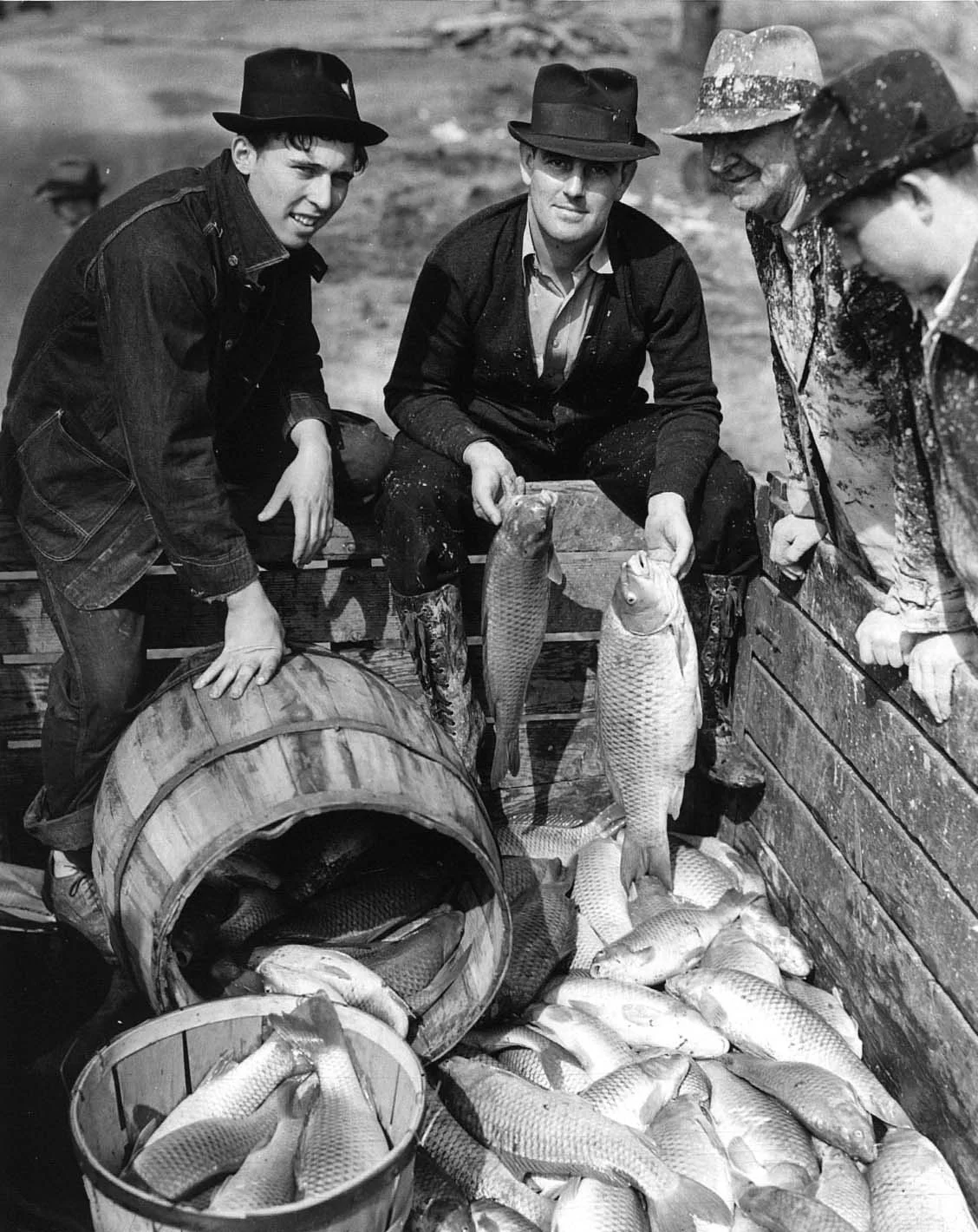 "J.W. Bush (second from left) and carp caught in land-locked flood waters of the Cumberland River in North Nashville, TN. 3/14/1939"