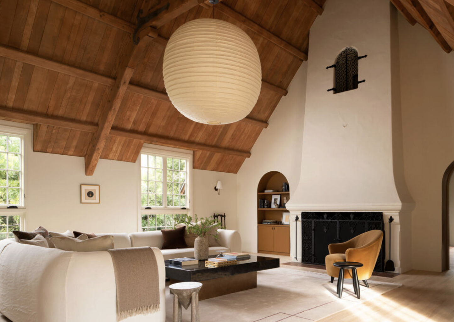 Living room with wood-paneled vaulted ceiling and fireplace at Laughlin Park estate in Los Feliz