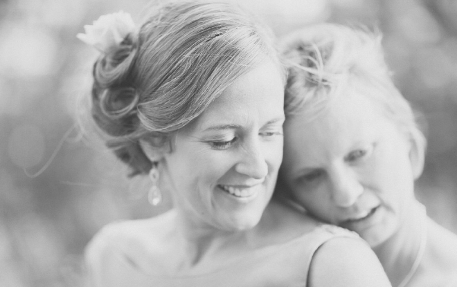 Natural black and white portrait of bride and bride sharing a loving moment together.