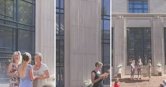 Non traditional Wedding ceremony in bright sunshine, in Wellington Civic square, with the old library building as a backdrop.