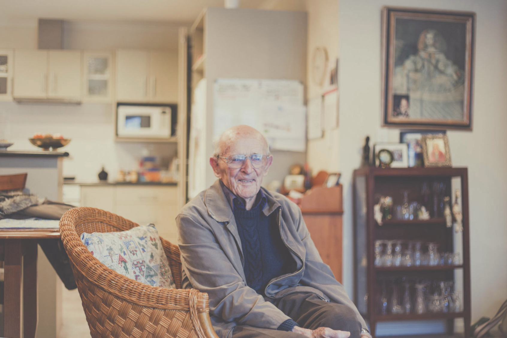 Portrait of a loving grandfather, watching on as his great grandchildren play.